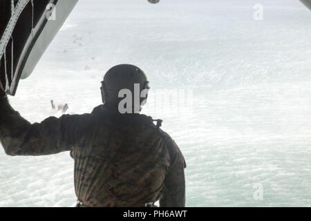 MARINE CORPS BASE HAWAII (30 juin 2018) UN U.S. Marine avec 3e Bataillon de reconnaissance se prépare à passer d'un CH-53E Super Stallion helo-cast hélicoptère durant la formation dans le cadre d'exercice Rim of the Pacific (RIMPAC) au large de la côte d'Hawaï Base du Corps des marines le 30 juin 2018. L'hélicoptère-cast de formation est destinée à préparer les membres de service pour une insertion amphibies au cours de l'exercice RIMPAC. RIMPAC fournit une formation de valeur pour la tâche-organisé, très-capable-sol marin Task Force et améliore la capacité d'intervention de crise critique de Marines américains dans le Pacifique. Vingt-cinq nations, 46 navires, f Banque D'Images