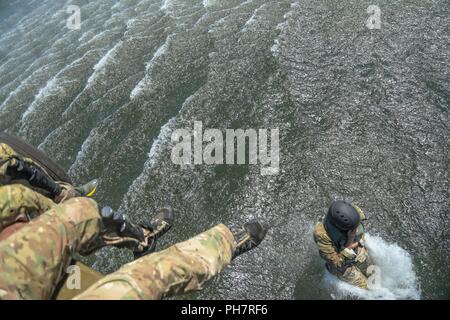 Un soldat de l'armée américaine, attribué à 10e Groupe des forces spéciales (Airborne), saute d'un hélicoptère UH-60 Blackhawk dans Chatfield réservoir pendant un événement de formation helo-cast de Littleton, Colorado, Jun. 29, 2018. L'un des objectifs accompli avec cet événement de formation était de renforcer leur capacité d'attaque de l'air ainsi que la mer. Banque D'Images