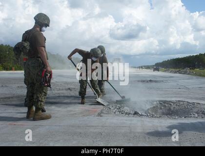 La base aérienne Tyndall, en Floride (Juin 28, 2018) attribué à Seabees Mobile Naval Construction Battalion 1 retirer les débris de autour d'un cratère sur une piste à l'aérodrome de réparation de dommages (ADR) expérience à la Tyndall Air Force Base à Panama City, Floride. Marine Expeditionary Combat Command a effectué l'essai de neutralisation des explosifs et des Seabees, personnel et des chercheurs pour valider les méthodes ADR et tester de nouvelles technologies visant à accroître l'ADR l'efficacité et la sécurité. Banque D'Images