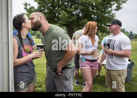 Mark Bowdish, un ancien infirmier de la réserve de l'Armée de la 303e Compagnie de Police militaire de Jackson, dans le Michigan, embrasse sa petite amie, Marilyn Nido, au cours de l'assemblée 'heureux vivant jour' picnic il organise pour célébrer la vie avec ses collègues, amis et famille à Stockbridge, Michigan, le 16 juin 2018. Bowdish a été tué par les talibans à quatre reprises au cours d'une attaque contre lui et ses soldats ont survécu à Kandahar, Afghanistan, le 19 juin 2012. Bowdish héberge le pique-nique pour montrer que l'unité dans la fraternité militaire est plus forte que les ennemis qui les attaquent. Douze soldats de l'unité a reçu l'Purpl Banque D'Images