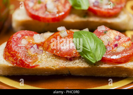 Avec pain de campagne tomates zebra noir et d'huile d'olive Banque D'Images