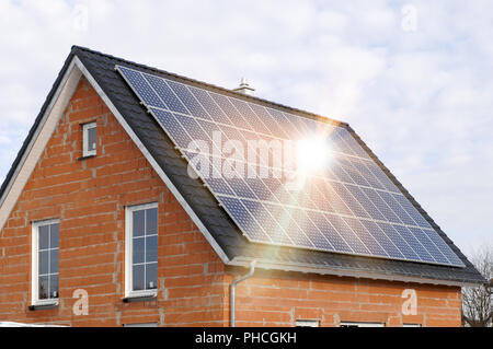 Des panneaux solaires sur toit résidentiel avec rayons de soleil Banque D'Images