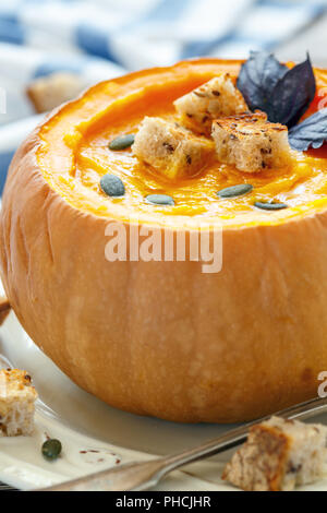 Soupe au potiron avec des croûtons dans un gros plan de la citrouille. Banque D'Images