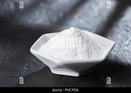 Le bicarbonate de soude dans un bol sur la table en bois, Close up Banque D'Images