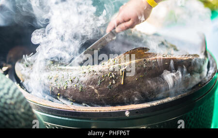 Le poisson fumé barbecue de jardin et la fumée le processus de fumer. Banque D'Images