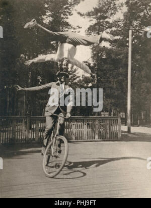 Années 1920 hommes sur un vélo. La Swedish location acrobat Fritiof Malmsten est l'exécution de la loi sur l'équilibre avec son jeune frère Helge. Une performance impressionnante où il est debout sur sa tête et de ne pas utiliser ses mains pour maintenir son équilibre. Malmsten Fritiof est devenu connu à l'étranger location acrobat. Banque D'Images