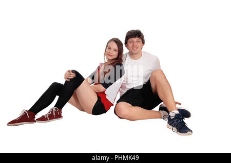 Couple sitting in sportswear sur le plancher Banque D'Images