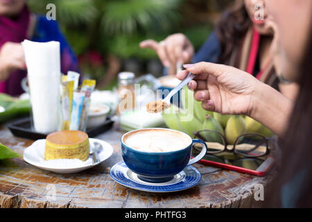 Groupe familial ayant de la nourriture avec le café et le sucre brun Banque D'Images