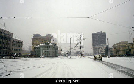 5 mars 1993 pendant le siège de Sarajevo : la conduite est à travers la neige sur Sniper Alley. Jusqu'à venir est une Organisation des Nations Unies pour Peugeot 206 Français (armoured personnel carrier). Peints en jaune le Holiday Inn Hotel est sur la gauche et en face, c'est le Conseil exécutif de l'immeuble, pris pour cible par l'artillerie Serbe au début du siège. Banque D'Images