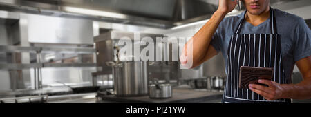Image composite de waiter talking on mobile phone while holding digital tablet Banque D'Images