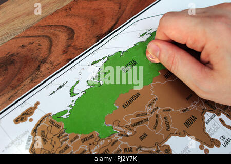 La main de l'homme pour gratter a visité les lieux sur une carte. Voyage en Russie. Un concept des destinations de voyage Banque D'Images