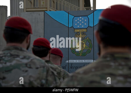 L'AÉRODROME DE BAGRAM, en Afghanistan (28 août 2018) -- Les membres de la communauté des opérations spéciales se rassembler devant une peinture murale au cours de la cérémonie de remise de la médaille d'honneur de l'US Air Force pour le sergent-chef. John Chapman sur l'aérodrome de Bagram, en Afghanistan, le 28 août 2018. La murale a été peinte en mémoire de Chapman pour ses actions héroïques lors de la bataille de Takur Ghar. (U.S. Photo de l'Armée de l'air par le sergent. Kristin élevée) Banque D'Images