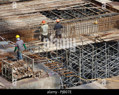 Les travailleurs de la construction de l'installation de la barre de renfort sur le chantier de construction. La barre de renfort est l'élément principal pour le renforcement du béton. Banque D'Images