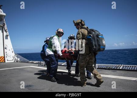 Océan Pacifique (11 juillet 2018) Cremembers à bord-côte de la Garde côtière canadienne 750 Bertholf (WMSL) transporter un patient au cours d'un exercice d'évacuation médicale au cours de Rim of the Pacific (RIMPAC). Vingt-cinq nations, plus de 46 navires et sous-marins, 5 sur 200 avions et 25 000 personnes participent à l'EXERCICE RIMPAC du 27 juin au 2 août dans et autour de l'île hawaïenne et du sud de la Californie. Le plus grand exercice maritime international RIMPAC, fournit une formation unique alors que la promotion et le soutien de relations de coopération entre les participants essentiels pour assurer la s Banque D'Images