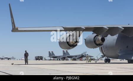 F-15E à partir de la 366e Escadre de chasse, Mountain Home Air Force Base, Texas sont pris en charge par un C -17 affecté à la 60e/349e Escadre de la mobilité aérienne, Travis Air Force Base, en Californie dans le cadre d'un concept à la base Gowen Field, Boise, Idaho le 12 juillet 2018. L'exercice était partie de Gunfighter drapeau, un exercice visant à intégrer plusieurs agences et unités. Banque D'Images