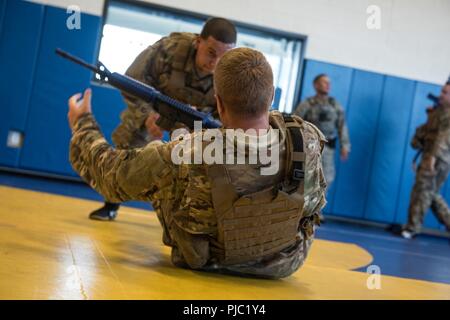 Les forces de sécurité d'un spécialiste de la 193e Escadron d'opérations spéciales les forces de sécurité, New York Air National Guard, les tentatives de passage à ses pieds lors d'une rétention d'armes percer le 11 juillet 2018, à l'école secondaire Middletown de Middletown, Connecticut. Le 193e SOSFS aviateurs terminé un cours de trois jours sur les tactiques défensives enseignées par F.O.R.C.E. Progressive Les concepts. Banque D'Images