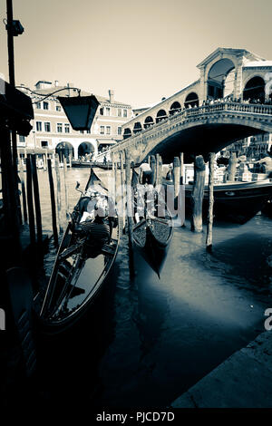 Deux gondoles étant prêt pour un tour sur le Grand Canal à Venise, tandis que les touristes regardant la scène du Pont du Rialto, dans l'arrière-plan Banque D'Images