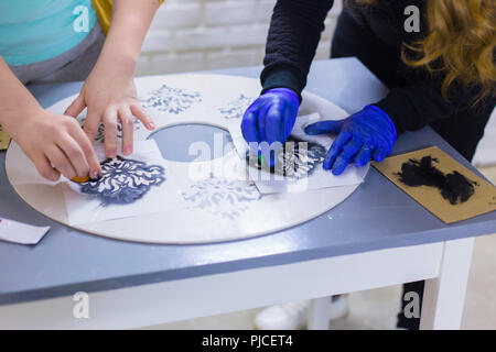 Les mains des femmes cercle en bois Peinture Banque D'Images