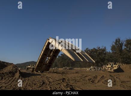 Réserve de l'armée américaine combat engineer Les soldats utilisent une Vehicle-Launched M60 Armored pont à traverser un écart d'une infraction au cours d'un exercice d'entraînement de soutien au combat (CSTX) à Fort Hunter Liggett, Californie, le 22 juillet 2018. Cette rotation des CSTX traverse le mois de juillet, la formation de milliers de soldats de réserve de l'Armée américaine à partir d'une variété de fonctions pour inclure la police militaire, médicales, chimiques, de la logistique, transport et plus encore. Banque D'Images