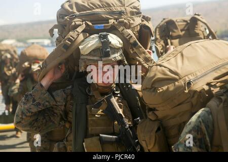 POHAKULOA SECTEUR D'ENTRAÎNEMENT (12 juillet 2018) UN U.S. Marine avec 1er Bataillon, 3e Régiment de Marines porte son équipement après déchargement d'un débarquement amphibie de débarquement mécanisé affecté à la Royal Australian Navy landing helicopter dock shop HMAS Adelaide (L01) au secteur d'entraînement de Pohakuloa dans le cadre de l'exercice Rim of the Pacific (RIMPAC), le 12 juillet 2018. RIMPAC fournit une formation de valeur pour la tâche-organisé, très-capable Marine-Air Task Force au sol et améliore la capacité d'intervention de crise critique de Marines américains dans le Pacifique. Vingt-cinq nations, plus de 45 navires et sous-marins, à propos de Banque D'Images