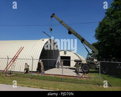 Des soldats de la réserve de l'Armée américaine à partir de la 317e compagnie du génie, hors de Homewood, Ill., assembler les sections métalliques de 4 000 pieds carrés sur une hutte quonset à Joliet, en Illinois, Elwood, dans le cadre d'un projet d'appui aux troupes pendant leur entraînement annuel, le 18 juillet. Banque D'Images