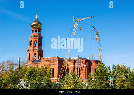 Grue de construction près de l'église en construction. La construction de temples orthodoxes en Russie. Restauration de la coupole de l'Église Banque D'Images