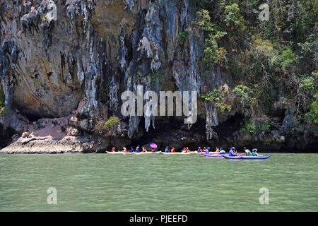 Les touristes d'explorer avec les roches calcaires érodés en canoë dans la baie de Phang Nga, la Thaïlande, l'Touristen erkunden mit dem Kanu erodierte Kalksteinfelsen dans Banque D'Images