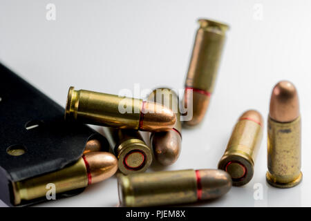 Bullet coquilles et un fusil close up clip. Macro de bullet cuivre arme tours isolé sur fond blanc. Banque D'Images