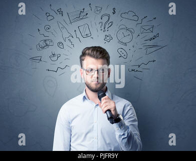 Businessman parlant au micro avec des doodles sur sa tête Banque D'Images