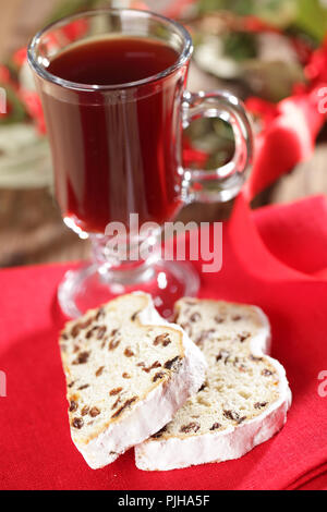 Stollen de Noël et le verre de vin chaud contre couronne de Noël Banque D'Images