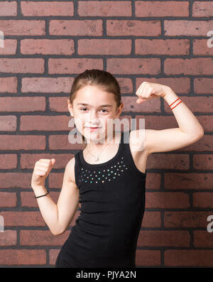 Jeune fille avec une moustache de lait gesticulant devant expressivement un mur arrière-plan. Banque D'Images