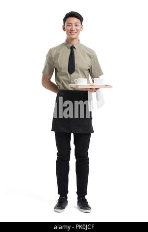 Young waiter holding tasses de café Banque D'Images