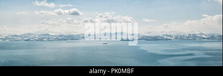 Panorama de la Baie d'Avacha recouvert d'une fine couche de glace à Yichun et vue sur les collines couvertes de neige et de volcans en hiver par temps clair Banque D'Images