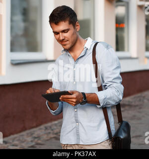 Happy young male executive using digital tablet. Banque D'Images