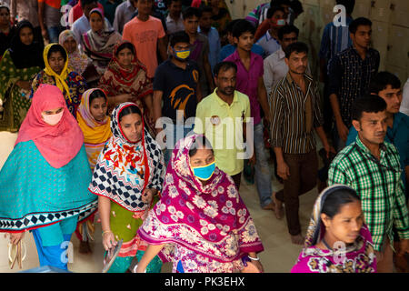 Les travailleurs du vêtement pour laisser leur pause déjeuner à une usine de vêtements au Bangladesh Banque D'Images