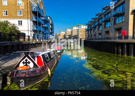 Les bateaux-maisons et les immeubles à appartements par le Limehouse Cut entrer dans le bassin de Limehouse, Docklands, London, UK Banque D'Images