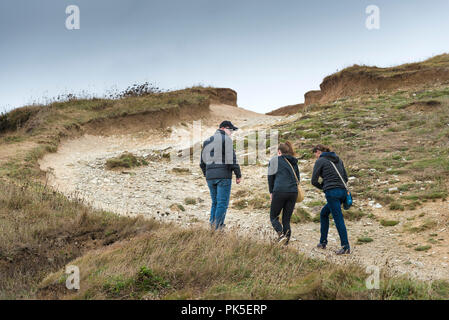 Les touristes marcher sur une section fortement érodé du South West Coast Path sur la côte nord des Cornouailles. Banque D'Images