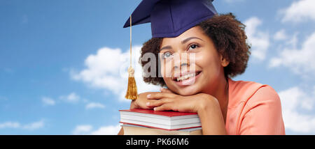 Close up of African graduate student with books Banque D'Images