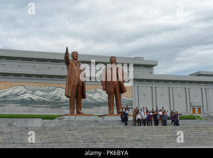 La Corée du Nord, la troupe artistique Mansudae Hill Grand Monument, statues de Kim Il Sung et Kim Jong Il, avec mosaïque de Paekdu montagne derrière.avec les touristes visiteurs Banque D'Images