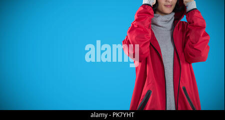 Image composite de femme en veste standing against white background Banque D'Images