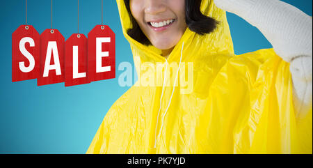 Image composite de femme portant imperméable jaune contre fond blanc Banque D'Images