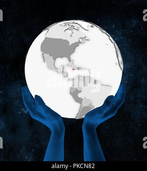 La Jamaïque en rouge sur blanc globe tenue en mains dans l'espace. 3D illustration. Banque D'Images