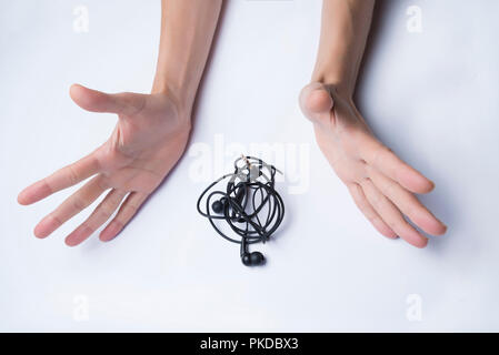 Mains tendues près d'emmêler le casque sur un fond blanc. Banque D'Images