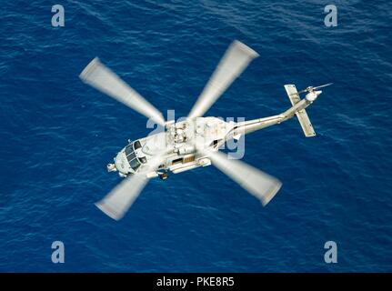 Océan Pacifique (Juillet 29, 2018) - MH-60R Un hélicoptère Sea Hawk, affecté à la "Blue Hawks" de l'Escadron d'hélicoptères grève maritime (HSM) 78, vole au-dessus de l'océan Pacifique. 78 HSM est en cours avec le porte-avions USS Carl Vinson (CVN 70) participant à l'exercice Rim of the Pacific (RIMPAC). Vingt-cinq nations, 46 navires, 5 sous-marins, environ 200 avions et 25 000 personnes participent à l'EXERCICE RIMPAC du 27 juin au 2 août dans et autour des îles Hawaï et la Californie du Sud. Le plus grand exercice maritime international RIMPAC, fournit une formation unique wh Banque D'Images