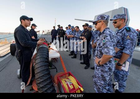 SAFAGA, Egypte (28 juillet 2018) Dommage Controlman 3e classe, Christian Orellana explique de-fumeurs équipement pour les marins des pays participants d'exercice Eagle Salute 18 au cours d'une démonstration de lutte contre les avaries à bord du destroyer lance-missiles USS Jason Dunham (DDG 109). Salut Eagle 18 est un exercice de la surface avec la Force navale égyptienne menée pour améliorer l'interopérabilité et l'état de préparation au combat, fortifier les relations militaires et de faire progresser les capacités opérationnelles de l'ensemble des unités participantes. Jason Dunham est déployé sur le 5e flotte américaine zone d'opérations à l'appui de n Banque D'Images