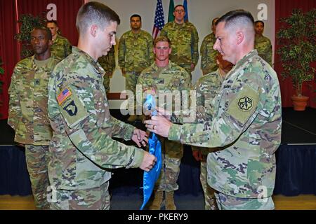 Le Lieutenant-colonel de l'armée américaine Jared A. Hoffman (à droite), commandant du 522ème bataillon de renseignement militaire, et le capitaine Jesse R. Cooper (à gauche), nouveau commandant de la société guidon se déploient au cours de l'activation et de prise de commandement pour Charlie détachement, 522ème bataillon de renseignement militaire à Caserma Ederle à Vicenza, Italie, le 31 juillet 2018. Banque D'Images