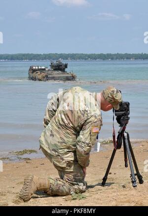 Le Sgt. Brandon Burk, un sous-officier des affaires publiques avec la 135e Détachement des affaires Public Mobile, de l'Iowa Army National Guard photographies marines dans le lac Margrethe avec leurs véhicules d'assaut amphibie à Camp Grayling, Michigan, le 8 août 2018. Une compagnie de marines, 4e, 4e Bataillon d'assaut amphibie Marine Division, U.S. Marine Corps de réserve des Forces canadiennes, Norfolk, Va., participent à Northern Strike, un projet conjoint interarmes multinationales exercice de tir réel. Banque D'Images