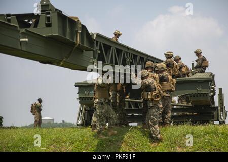 Les Marines et les marins se préparent à lancer un changement de nez pendant la phase de démontage d'un système multi-niveau opération relais 9 août 2018 au Camp Hansen, Okinawa, Japon. Marines avec Bridge Company, 9e, 3e Bataillon d'appui du Groupe logistique maritime et naval de marins avec un bataillon de construction Mobile 5 montés et démontés un pont moyen, qui est utilisé pour transporter le personnel et le matériel sur de grandes lacunes et les plans d'eau. Banque D'Images