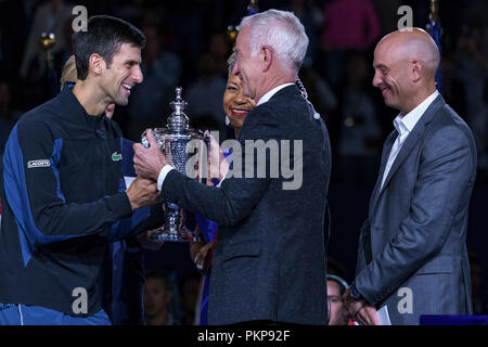 John McEnroe, présente le trophée à Novak Djokovic (SRB) pour la finale chez les hommes à l'US Open de Tennis 2018. Banque D'Images