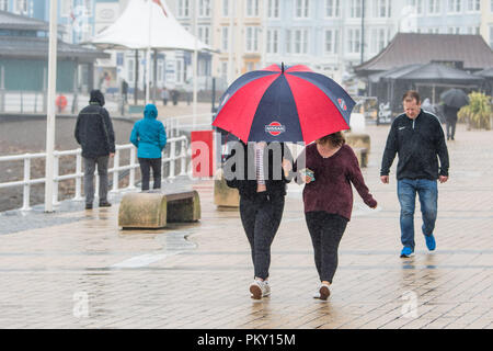 Aberystwyth, Pays de Galles, Royaume-Uni. 16 septembre 2018 UK Weather : personnes marchant le long de la promenade du front de mer à Aberystwyth , Pays de Galles sur un morne et humide dimanche après-midi de septembre. L'ouest de la France se prépare donc pour l'impact de la tempête Hélène, qui est prévu de faire la grève du jour au lendemain, le lundi, avec des vents soufflant jusqu'à 70 mi/h dans les zones exposées, , avec le risque de danger à la vie à partir de la projection de débris Photo © Keith Morris / Alamy Live News Banque D'Images